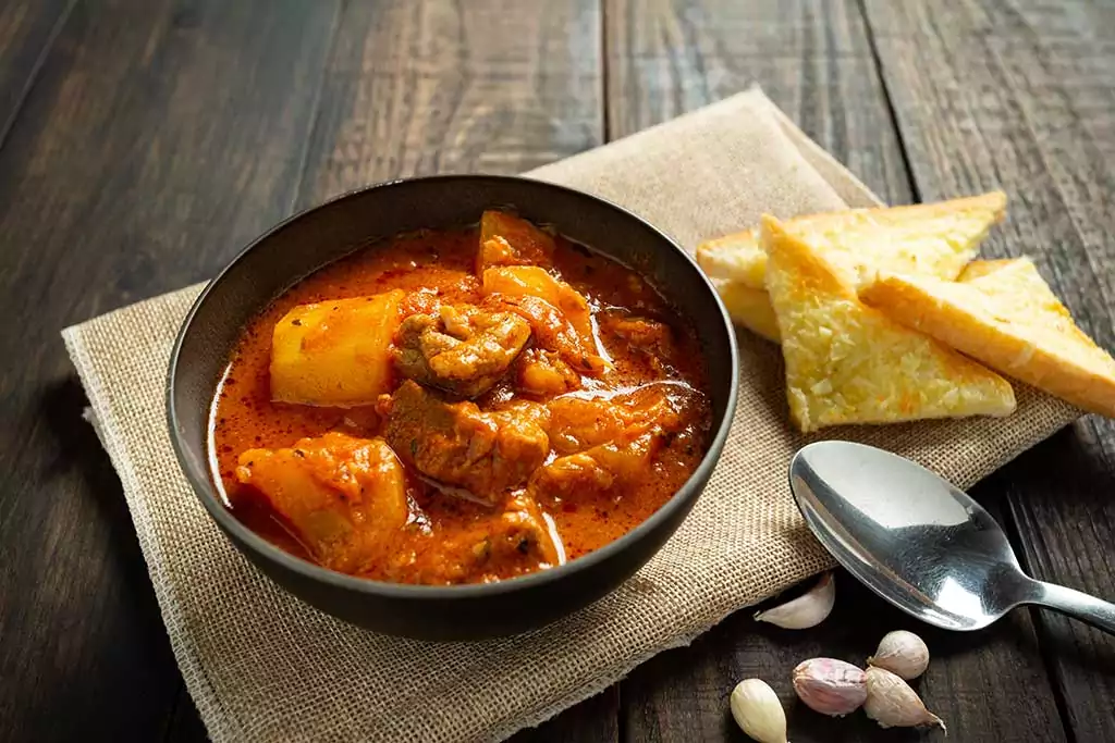 Goulash soup on wooden background.