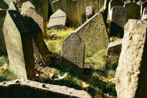 Historic old Jewish cemetery with rock tombs in Prague and broke