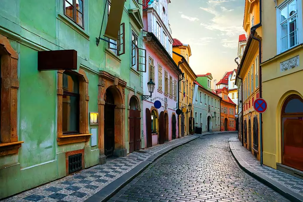 Narrow street in the old district of Prague at sunrise